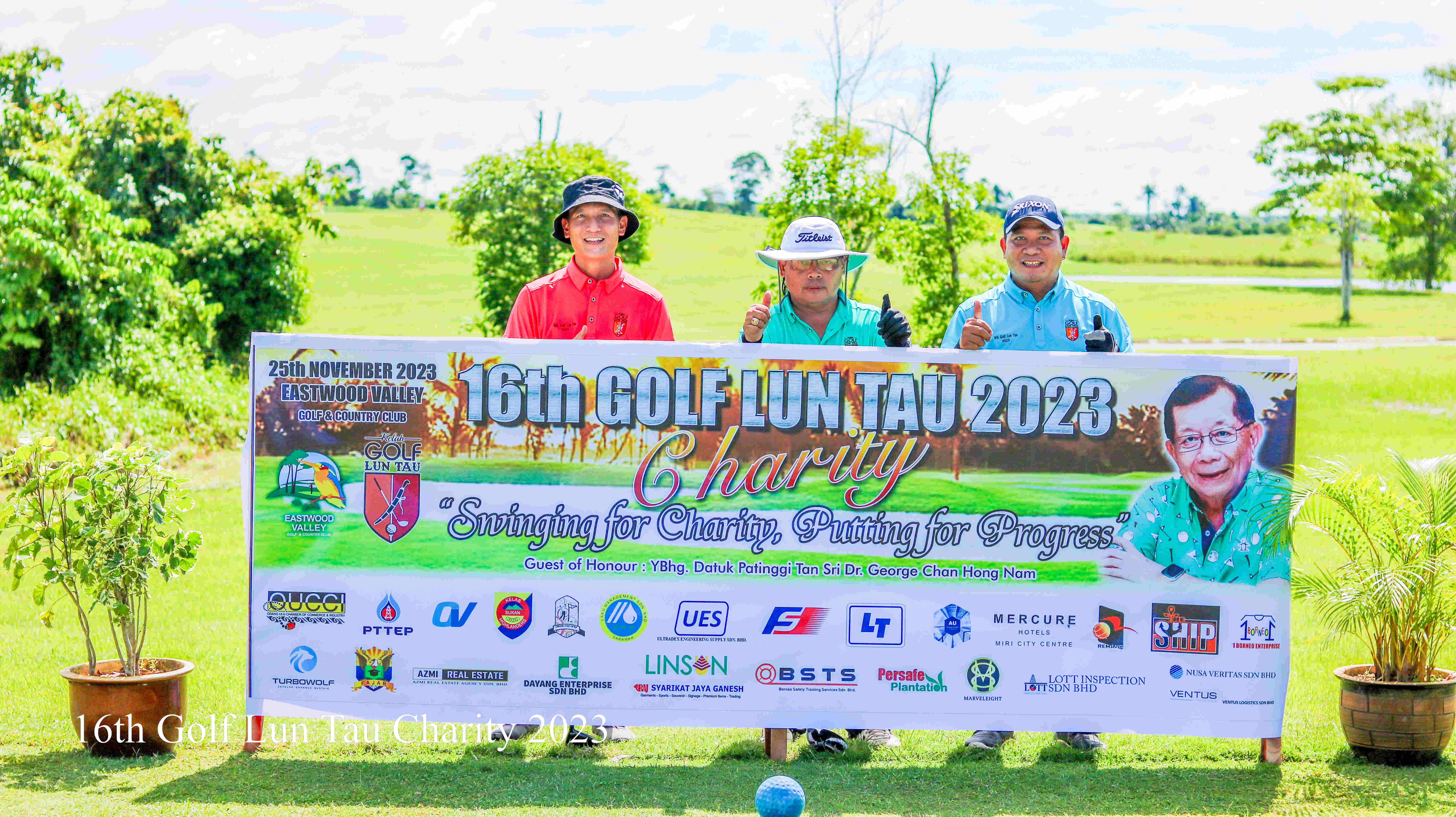 Three community members holding a charity banner, symbolizing our mission to promote community and belonging through golf